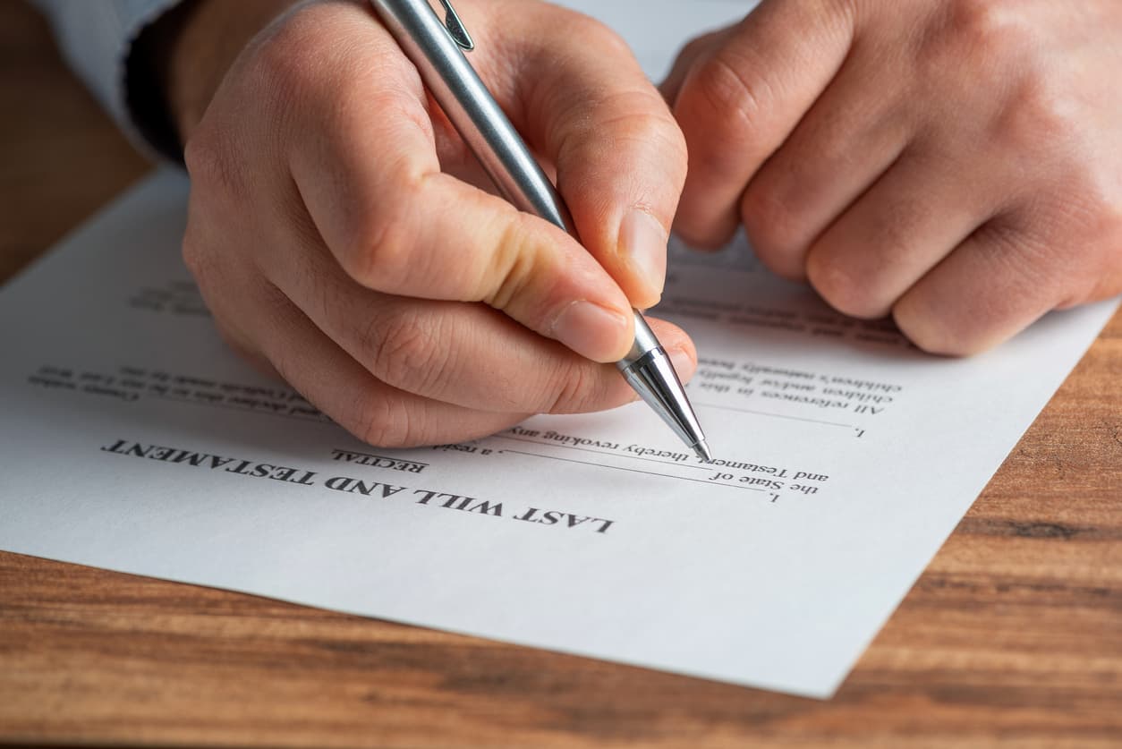 Determining which assets to include when writing your will. A concept of making a will - Man filling out his last will and testament.